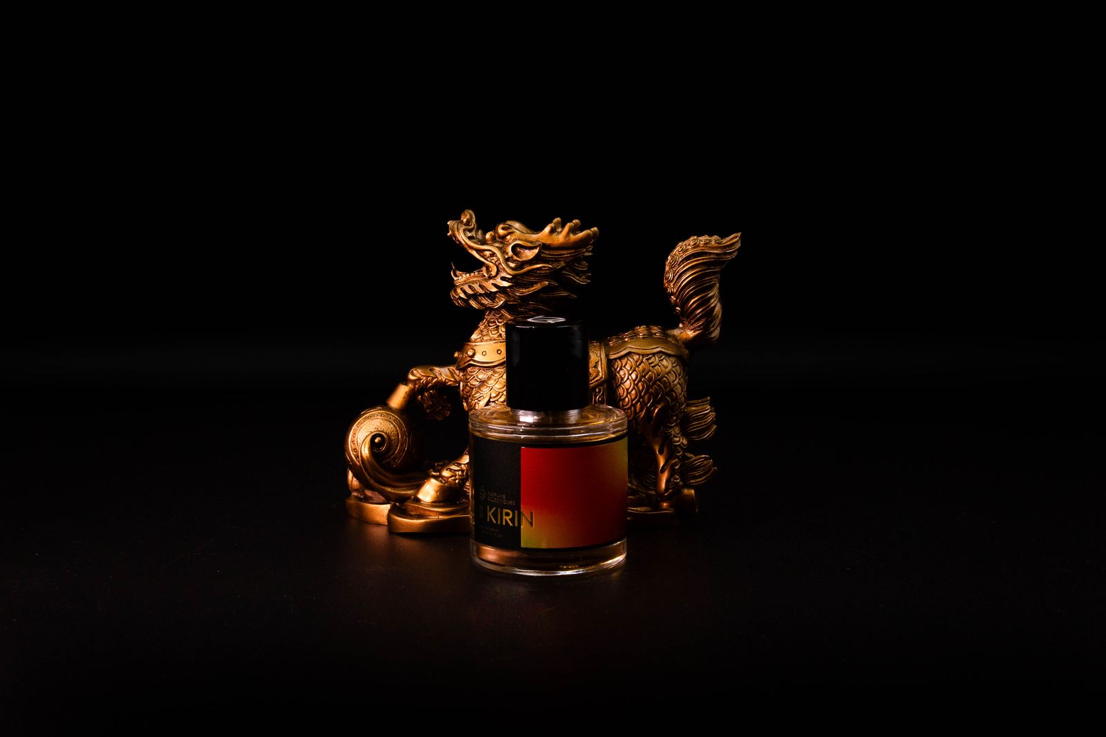Kirin eau de parfum in front of a gilded dragon figure